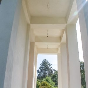 Säulengang, überdacht mit eckigen Pfeilern in einem hellen Cremeton